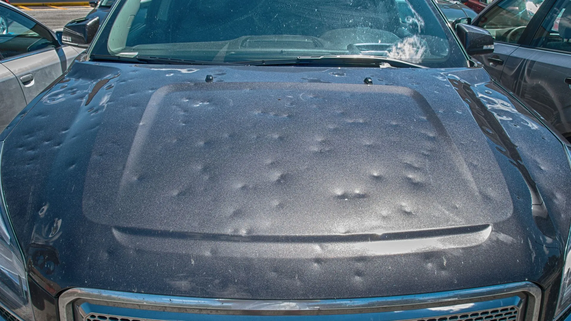 Technician performing auto body dent repair